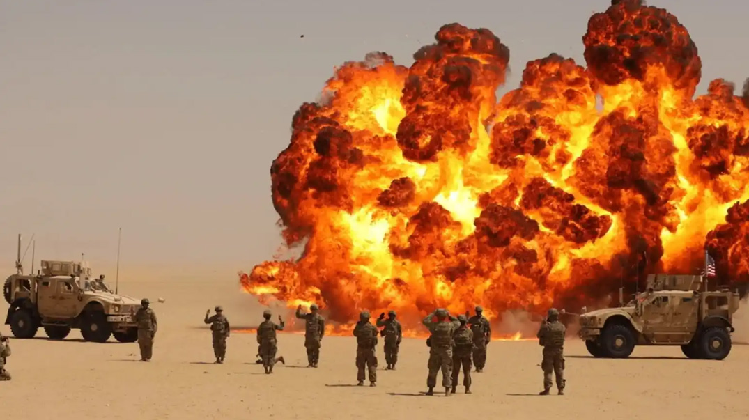 Soldiers reenlisting with a huge explosion in the background.